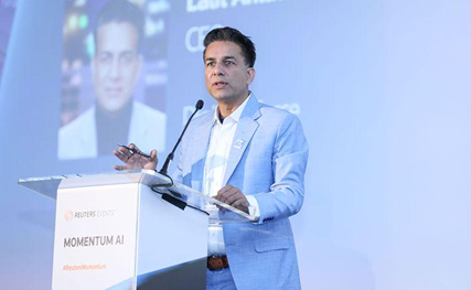 This photo shows a DigitalXForce leader speaking at a conference lectern.